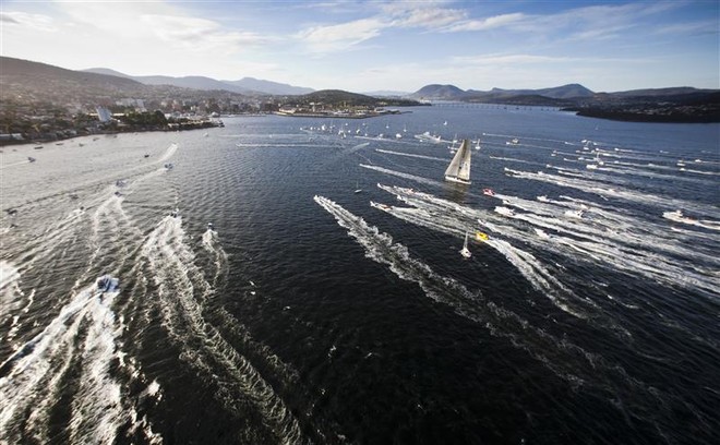 INVESTEC LOYAL escorted by spectator craft before crossing the finish line - Rolex Sydney Hobart Yacht Race 2011 ©  Rolex/Daniel Forster http://www.regattanews.com